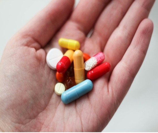 Hand holding pills
